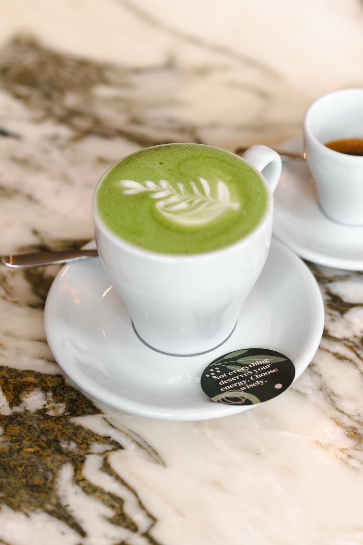 A matcha latte served in a café with a LuckySip message card